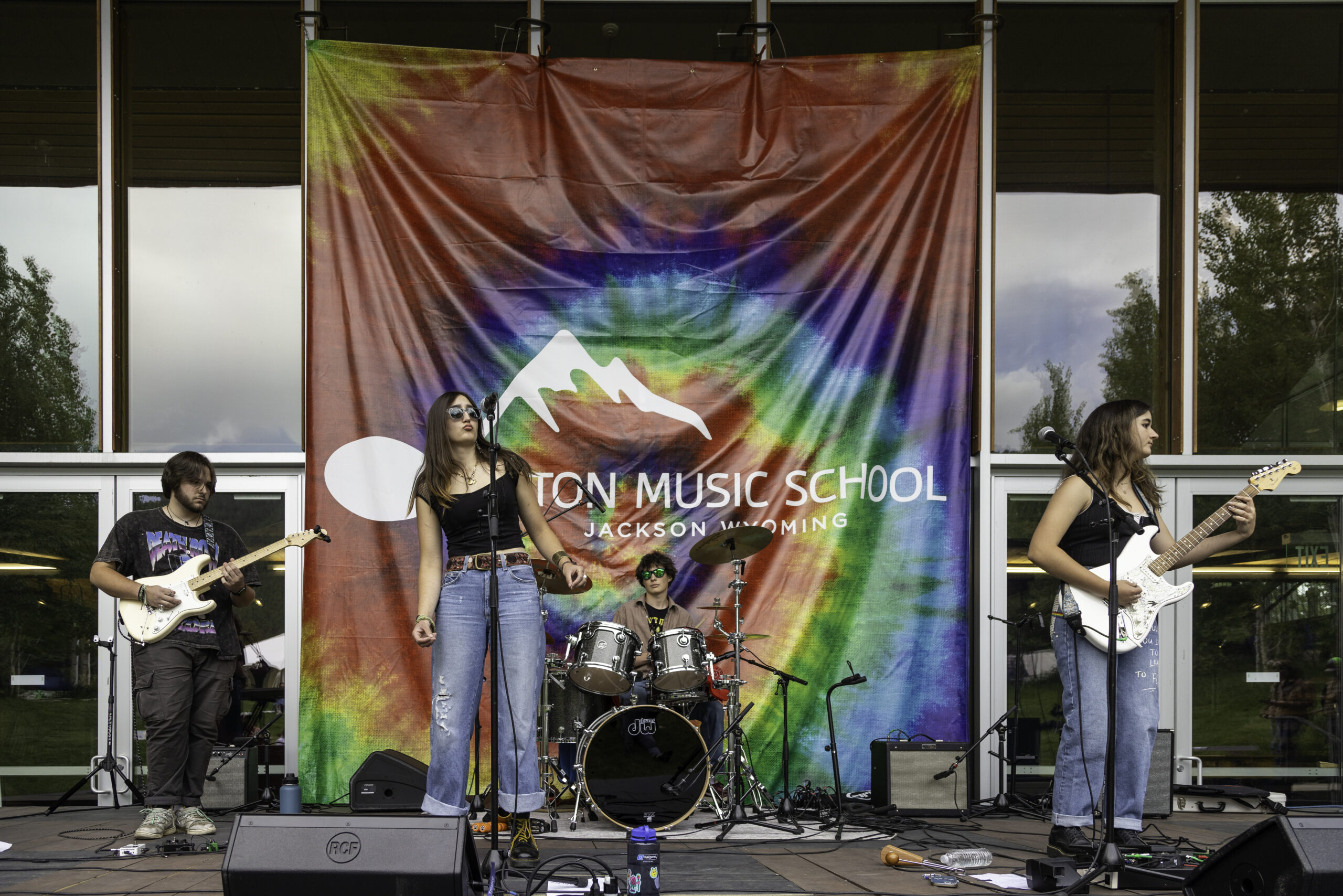 Teen rock band playing at a Teton Music School performance outside in The Center Amphitheater
