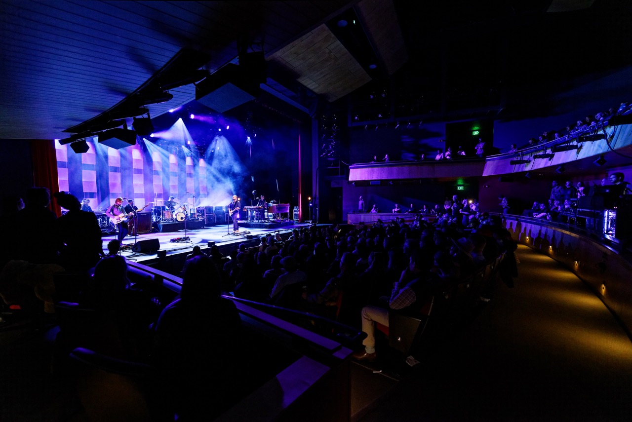 Concert-goers watching live music by a rock band in The Center Theater in Jackson, Wyoming