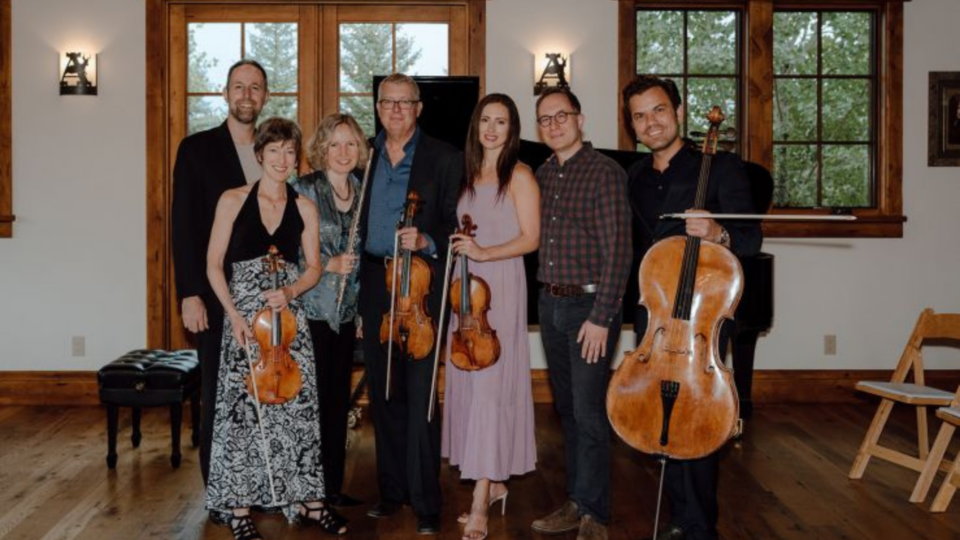 A group of people at Jackson Hole Chamber Music holding their instruments