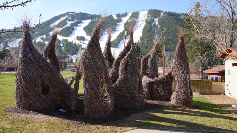 Patrick Doherty exhibit outside the Center, wooden structures in the shape of a tepee with windows cut out